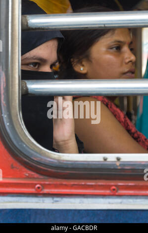 Muslim and Hindu women on a bus in Mumbai India Stock Photo