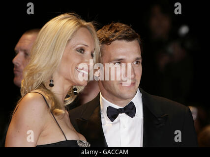 Andriy Shevchenko and wife Kristen arrive for Swarovski Fashion Rocks for The Prince's Trust at the Royal Albert Hall in central London. Stock Photo