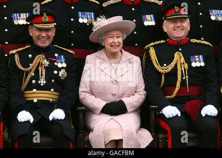 Great Britain's Queen Elizabeth II poses for a photograph, accompanied by Chief Royal Engineer Sir Kevin O'Donoghue (left) and Brigadier Chris Sexton during a visit to the Corps of Royal Engineers at Brompton Barracks, Chatham, Kent. Stock Photo