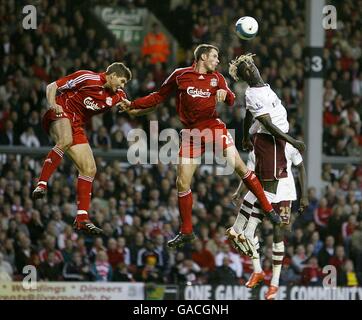 Arsenal's Bacary Sagna battles for the ball in the air with Liverpool's Steven Gerrard (left) and Jamie Carragher Stock Photo