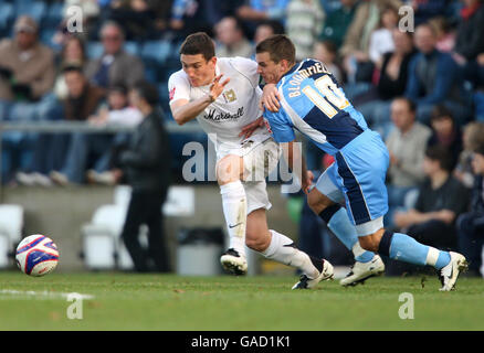 Wycombe's Matt Bloomfield and Milton Keynes Don's Keith Andrews compete for the ball during the Coca-Cola Football League Two match at Adams Park, High Wycombe. Stock Photo