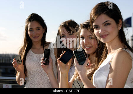 Classical girl group All Angels (left-right) Laura Wright, Charlotte Ritchie, Daisy Chute & Melanie Nakhla highlighting Universal Music Group's decision to remove copy protection across it's entire Classics & Jazz catalogue in a download trial, at Universal's head office in Kensington, west London. Stock Photo