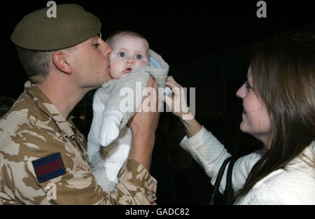 Lance Sgt. Kevin Tomlinson greets his baby son Luke, and wife Louise, after the final 60 soldiers of the 1st Battalion Irish Guards returned to their base at the New Mons Barracks, in Aldershot, from serving on operations in Iraq. Stock Photo