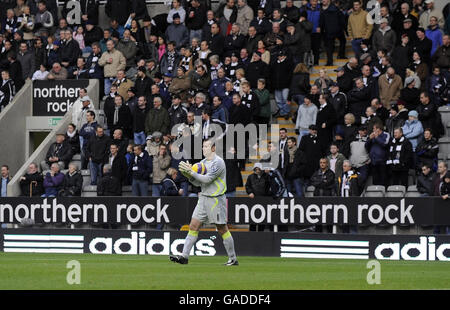 Newcastle United supporters sit behind billboards for Northern Rock as they watch their goalkeeper Shay Given during the Premiership Match between Newcastle and Liverpool on Satrurday November 24. Stock Photo