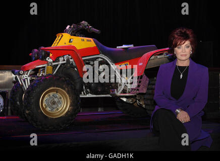 Sharon Osbourne sits next to her husband Ozzy's Quad Bike (upon which he had his life-threatening accident) ahead of a two-day auction (to be held at Gibson Guitar Showroom, Beverly Hills, CA on Friday and Saturday, 30th November and 1st December) of art, memorabilia &amp; furnishings from the Osbourne's homes in Beverly Hills, Malibu and the UK at the Indigo2, The 02 Arena, Millennium Way, Greenwich, SE10 in London. Stock Photo