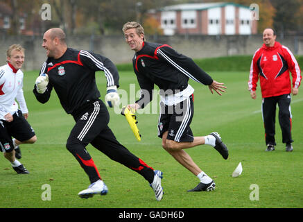 Liverpool's Pepe Reina (left) is chased by team mate Peter Crouch during a training session at Melwood Training Ground, Liverpool. Stock Photo
