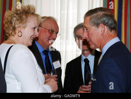 The Prince of Wales (right) with Pat Beanland (left) from Kings Norton Girls' School, Birmingham, at a reception which the Prince hosted at Clarence House, central London for head teachers from schools which sent delegates to The Prince's Teaching Institute Summer Schools. Stock Photo