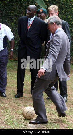 Prince Charles passes a football with Ugandan children at the Kampala Kids League football training centre in Uganda. The Commonwealth Heads of Government Meeting (CHOGM) is taking place in the capital, Kampala. Stock Photo