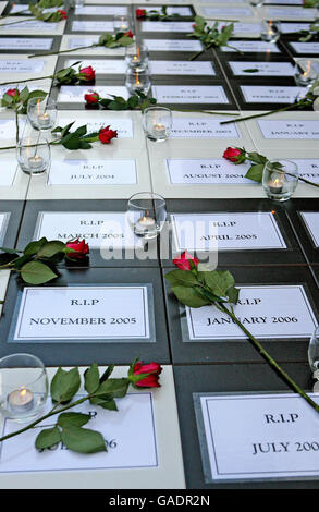 Members of Women's Aid mark the International Day for the Elimination of Violence against Women by standing beside an installation of 137 large black and white tiles outside Leinster House in Dublin, each one recording the date of a woman's murder in Ireland since 1996. PRESS ASSOCIAITON Photo. Stock Photo