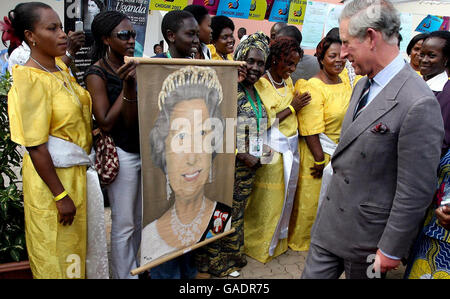 The Prince of Wales looks at a painting of Her Majesty the Queen at The Peoples Space, Africana Hotel in the Ugandan capital Kampala, where the Commonwealth Heads of Government Meeting (CHOGM) is taking place. Stock Photo