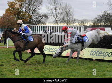 Graham Lee and Surricate (left) go on to win as his stablemate from the Ferdy Murphy yard Sharkeys Dream and Keith Mercer fall in the Bramham Hall for Conferences and Banqueting Beginners Chase at Wetherby Racecourse. Stock Photo
