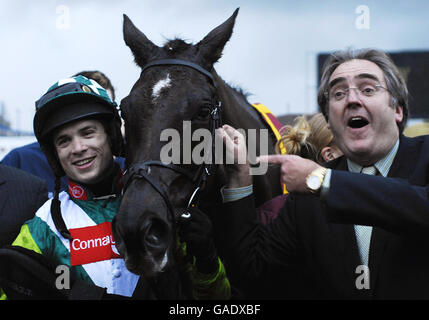 Denman and Sam Thomas with owner Harry Findlay after victory in The Hennessy Cognac Gold Cup at Newbury Racecourse. Stock Photo
