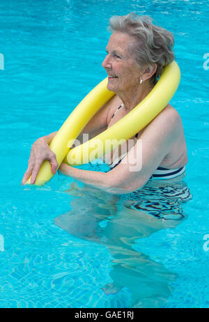 Healthy, older woman exercising in the pool Stock Photo