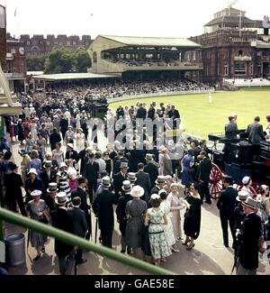 Spectators mingle at lunch during the annual cricket match Stock Photo