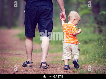 Father and son walking in the forest Stock Photo