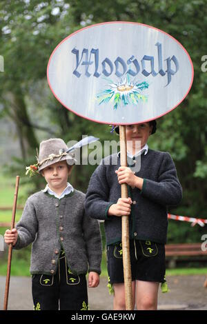 Boys carrying a Moosalp sign during Viehscheid, separating the cattle after their return from the Alps, Thalkirchdorf Stock Photo