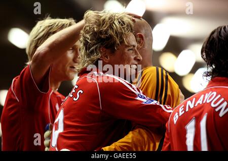 Liverpool's Fernando Torres (centre) celebrates with his team mates after scoring the first goal of the game. Stock Photo