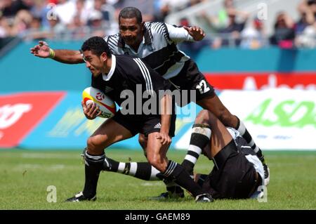 New Zealand's Mils Muliaina comes away from Fiji's Jope Tuikabe Stock Photo