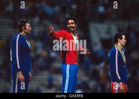 Great Britain's Daley Thompson (c) indicates the size of his achievement in beating USSR's Yuriy Kutsenko (l, silver) and Sergey Zhelanov (r, bronze) to the gold medal Stock Photo