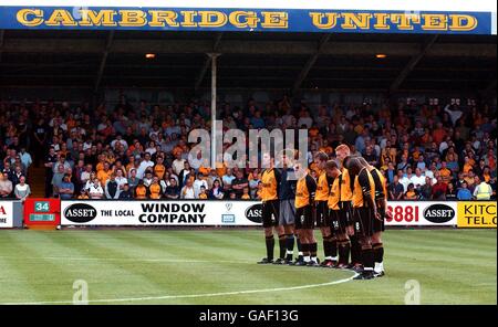 Soccer - Nationwide League Division Two - Cambridge United v Leyton Orient. Cambridge United's players observe a minutes silence at the start of the match for Holly Wells and Jessica Chapman