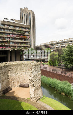 Remains of the old London Wall, adjacent to the Barbican housing complex, in the city of London with St Paul's in the distance Stock Photo