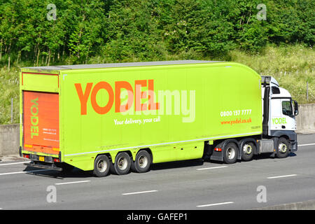 Yodel transportation logistics via articulated hgv parcel delivery lorry and trailer part of the uk supply chain driving along UK motorway in England Stock Photo