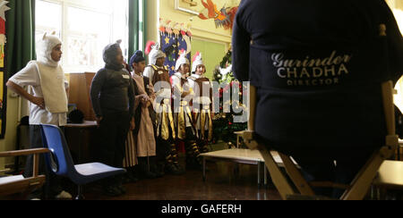 Year 6 pupils from Clifton Primary School in Southall, west London, with film director Gurinder Chadha - who is returning to her old school for the first time to craft a school production of their Christmas Nativity play. Stock Photo