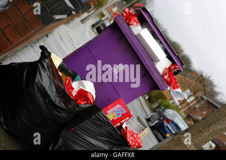 A rubbish bin in Liverpool overflows with wrapping paper and packaging from opened Christmas presents. Stock Photo