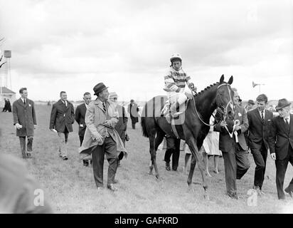 Horse Racing - The Irish Derby - The Curragh. Irish Derby winner Meadow Court, Lester Piggott up, with part owner Bing Crosby (l) walking alongside Stock Photo