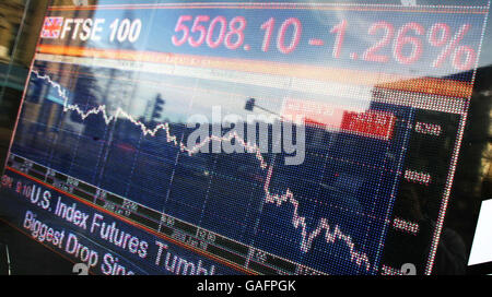 FTSE panic. A screen shows the FTSE 100 on the corner of North End Road and Cromwell Road in west London. Stock Photo