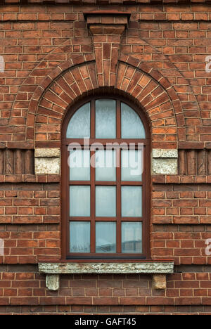 Window with an arch on the background wall of brown brick. From the series window of Saint-Petersburg. Stock Photo