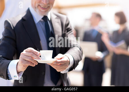 Cheerful businessman drinking coffee Stock Photo