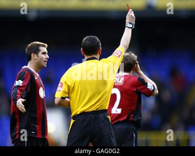 Referee Andre Marriner shows the Red card to Fulham's Moritz Volz (r) for his second bookable offence. Stock Photo