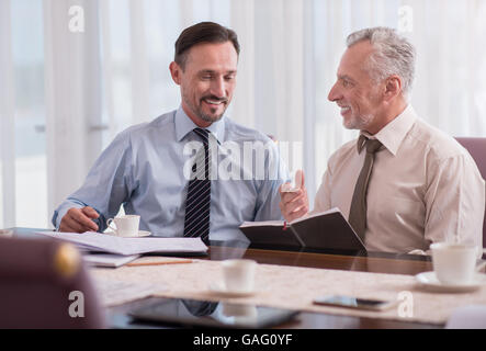 Positive colleagues having nice conversation Stock Photo