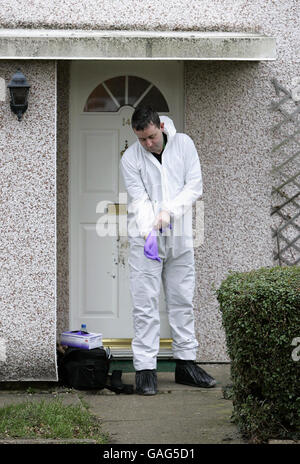 A police forensic scientist outside a house on The Spinney in Bedford where a man in his thirties armed with a knife died from self-inflicted injuries last night after he was shot by police with a stun gun during a domestic dispute. Stock Photo