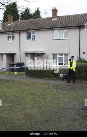 A police officer outside a house on The Spinney in Bedford where a man in his thirties armed with a knife died from self-inflicted injuries last night after he was shot by police with a stun gun during a domestic dispute. Stock Photo