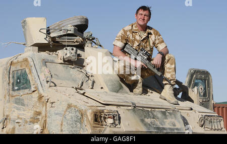 Corporal Kevin Walker, 31, of the Royal Electrical Mechanical Engineers (REME) from Auchinlech in Ayrshire, with a Viking 'Combat Taxi'. Stock Photo