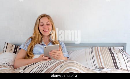 Beautiful young woman using tablet computer Stock Photo