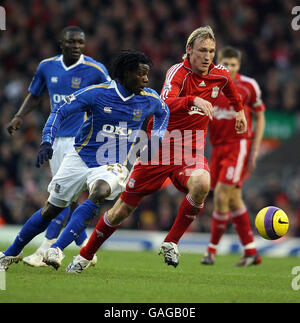 Soccer - Barclays Premier League - Liverpool v Portsmouth - Anfield. Portsmouth's Benjani Mwaruwari (left) in action with Liverpool's Sami Hyypia during the Barclays Premier League match at Anfield, Liverpool. Stock Photo