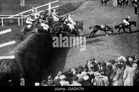 Horse Racing - The Grand National - Aintree - 1937. Becher's Brook second time around showing the winner 'Royal Mail' leading the field, ahead of 'Flying Minute' and 'Delachance'. Stock Photo