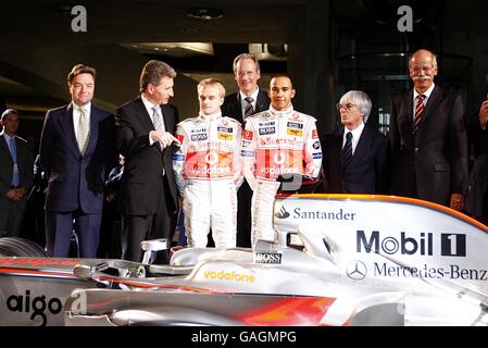 Vodafone McLaren Mercedes driver Lewis Hamilton (right from centre) and team mate Heikki Kovalainen (left from centre) with their management team during the launch of the Vodafone McLaren Mercedes MP4-23 at the Mercedes-Benz Museum, Stuttgart. Stock Photo