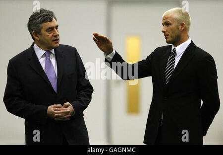 Britain's Prime Minister Gordon Brown chats with David Beckham during a visit to The David Beckham Academy in London. Stock Photo