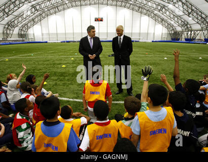 Britain's Prime Minister Gordon Brown chats with David Beckham during his visit to The David Beckham Academy in London. Stock Photo