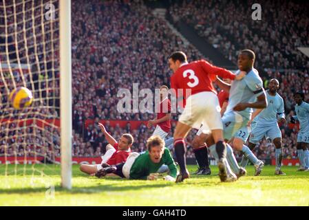 Manchester United goalkeeper Edwin Van der Sar dives in vain as Manchester City's Benjani Mwaruwari scores the second goal of the game. Stock Photo