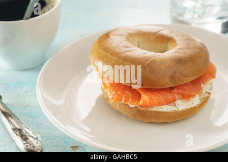Bagel with salmon and cream chees on white plate Stock Photo