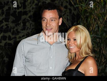 John Terry and wife Toni Poole arrive for the UK Premiere of Rambo at the Vue West End, London Stock Photo