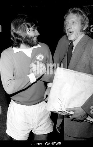 (L-R) Manchester United's George Best shares a joke with former teammate Denis Law before the match Stock Photo