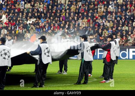 Soccer - UEFA Champions League - Group C - AC Milan v Real Madrid. The ballboys ripple the giant starball logo in the centre circle Stock Photo