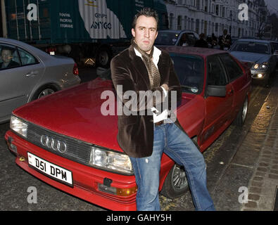 Virgin Radio disc jockey Christian O'Connell arrives at the Brit Awards Ceremony in a red Audi Quattro, similar to the one driven by Jean Hunt in the TV series Ashes to Ashes, Earls Court, London. Stock Photo