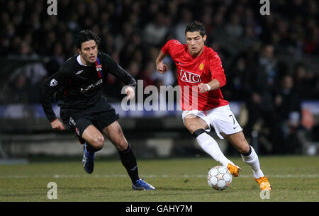 Manchester United's Cristiano Ronaldo goes past Lyon's Fabio Grosso during the UEFA Champions League First Knockout Round First Leg match at the Stade Gerland, Lyon, France. Stock Photo